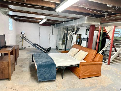 a bedroom with a bed and a couch in a room at The Dayton DreamHouse in Dayton