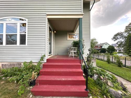 a house with a red staircase leading to the front door at The Dayton DreamHouse in Dayton