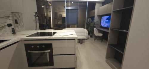 a kitchen with a stove and a living room at La Residence Panamá in Panama City