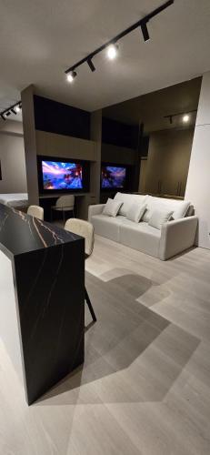 a living room with two beds and two televisions at La Residence Panamá in Panama City