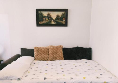 a bed in a room with a picture on the wall at Roosevelt Apartment Antwerp in Antwerp