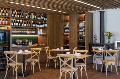 a restaurant with wooden walls and tables and chairs at Quinta da Amendoeira - Évora - The Farmhouse in Évora