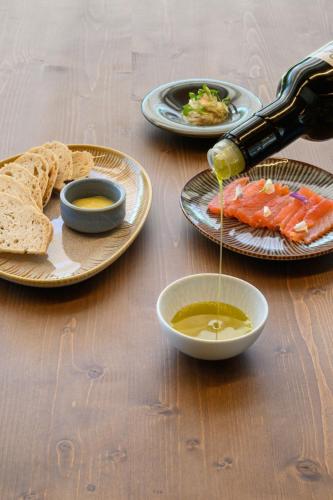 a table with plates of food and a bottle of sauce at Quinta da Amendoeira - Évora - The Farmhouse in Évora