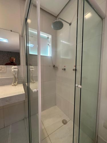 a shower with a glass door in a bathroom at Vila mangaba in São José dos Campos