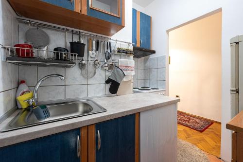 a kitchen with a sink and a counter top at Downtown Apartment Freedom in Podgorica