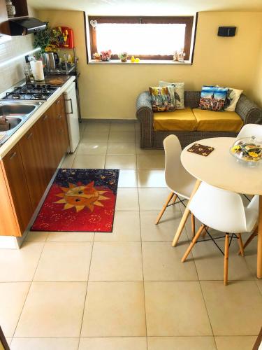 a kitchen and living room with a table and a couch at Residence Cuore in Caserta