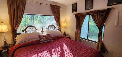 a bedroom with a bed with a large window at Lily Creek Lodge in Dahlonega