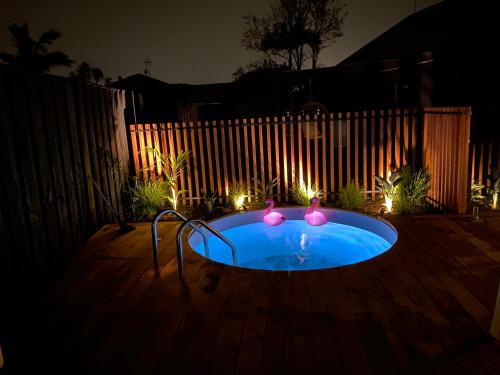 a small hot tub in a backyard at night at Large Mt Maunganui Family Villa in Mount Maunganui