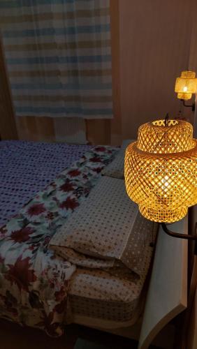 a bedroom with a bed with a lamp next to it at Lavagna - Chiavari modern apartment - vicino mare in Lavagna