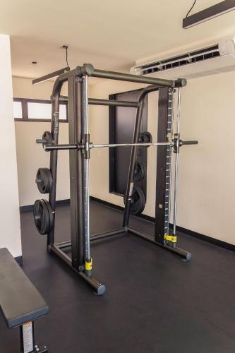 a room with a gym with a squat rack at Stay near Auditorio Telmex with A/C in Guadalajara