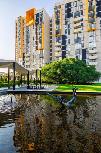 a statue of a duck in the water in front of buildings at Apartment A/C, GYM, Cafeteria | Telmex Auditorium in Guadalajara