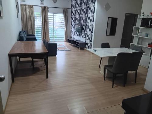 a living room with a table and a dining room at Imagine world in Tanah Rata