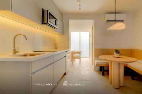 a kitchen with a sink and a table at Capitalia Antara Polanco in Mexico City