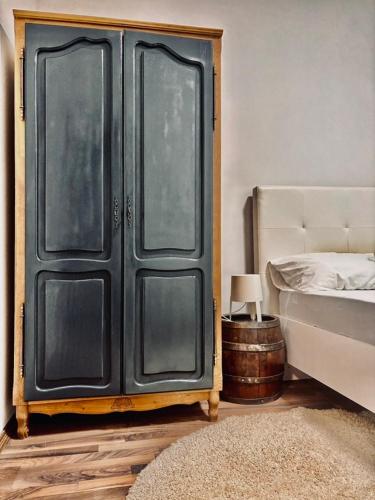a bedroom with a bed and a black door at Villa Srna Apartments 