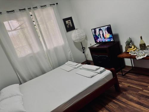 a bedroom with a white bed and a window at Villa Srna Apartments 