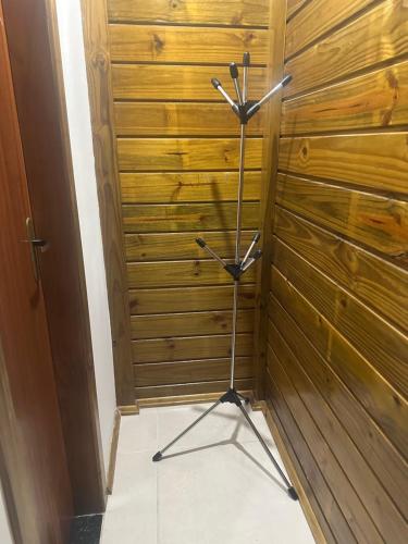 a metal stand in a room with wooden walls at Pousada Hostels Foryou in Ibiraçu