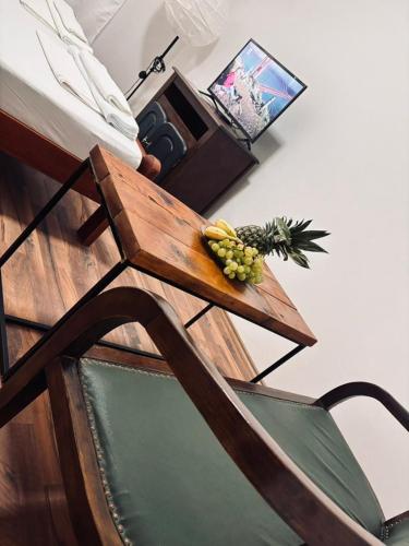 a wooden table with a bowl of fruit on it at Villa Srna Apartments 