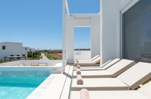 a villa with a swimming pool and a balcony at Sealove Villa in Lachania