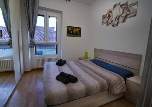 a bedroom with a bed with two black objects on it at centro di rho - rho fiera - vicino stazione in Rho