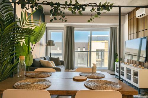a living room with a wooden table and chairs at The 708 - For 4 - Free Parking - BBQ in Quebec City