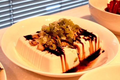 a piece of cake on a white plate on a table at 호텔 인썸니아 Hotel Insomnia 失眠酒店 in Daegu