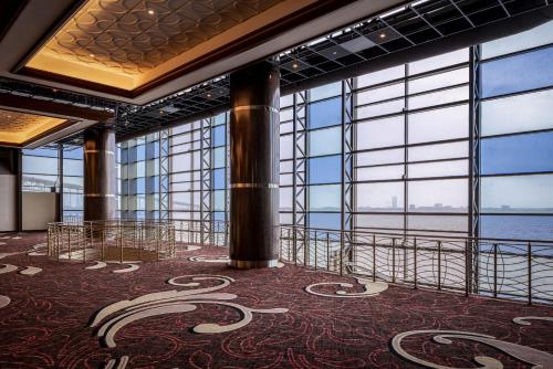 a room with large windows and a floor with a carpet at Horseshoe Lake Charles, A Caesars Destination in Lake Charles