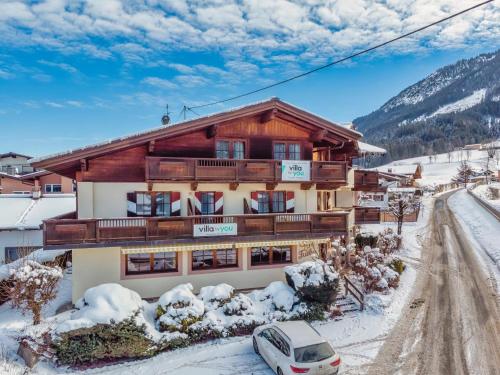 a house in the snow with a car parked in front at Oberleitner L in Brixen im Thale