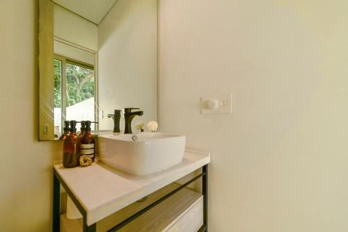 La Majahuaにある50m to Surf Saladita Casita with Luuna Mattress Pool Ice Bathの白い洗面台と鏡のあるバスルーム