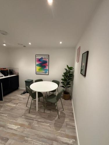 a table and chairs in an office with a table and a table at New City Centre Flat No 1 2 Bedrooms Free Parking in Leicester