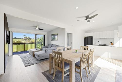 a kitchen and living room with a table and chairs at Luxury Hills Villa Retreat Phillip Island Resort in Cowes