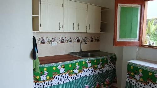 a kitchen with a sink and a counter top at Finca Balcones de Abba in Salento