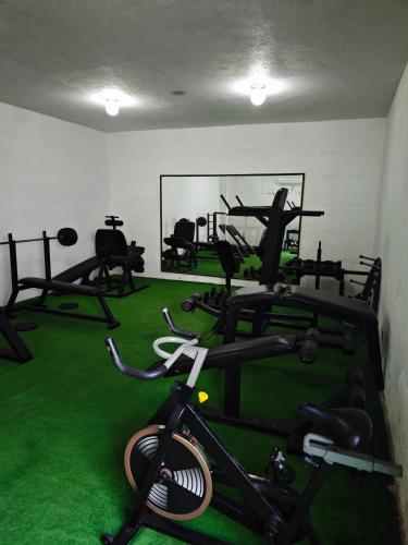 a gym with several tread machines in a room at Hermoso y moderno departamento 2Hab, club de paya in Manzanillo