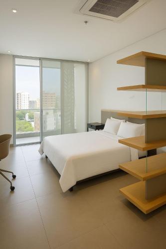 Ένα ή περισσότερα κρεβάτια σε δωμάτιο στο Distrito 90 Suites