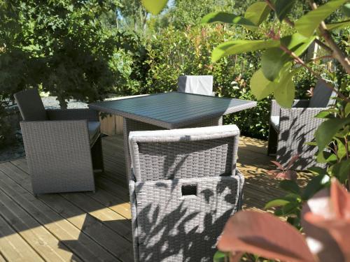 a table and chairs sitting on a deck at Gîte en bord de Loing à Montargis - Nature, culture et détente à une heure de Paris - FR-1-590-423 in Montargis