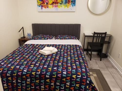 a bedroom with a bed with a comforter and a chair at Stylish City Escape in Toronto