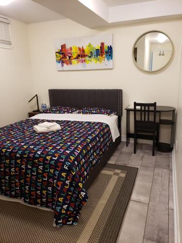 a bedroom with a bed and a chair and a mirror at Stylish City Escape in Toronto