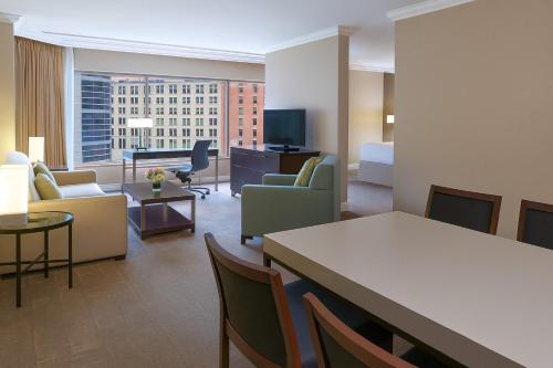a living room with a couch and a table and chairs at InterContinental Toronto Centre by IHG in Toronto