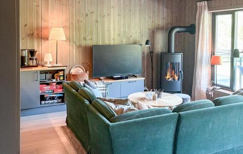 ヘムセダールにある3 Bedroom Awesome Apartment In Hemsedalの青いソファとテレビのあるリビングルーム