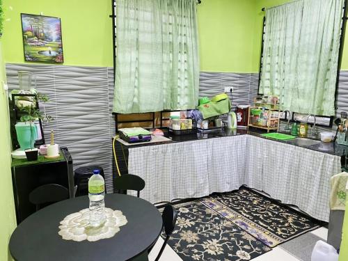 a room with a table and a counter with a table and chairs at Habib Homestay in Kuala Terengganu