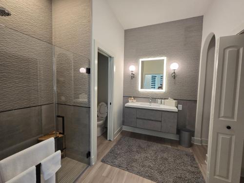 a bathroom with a sink and a toilet and a mirror at Modern ranch retreat near Trilith and US Soccer Training Facilities in Fayetteville