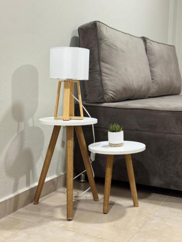 a table with a lamp on it next to a couch at Dpto centro CDE in Ciudad del Este