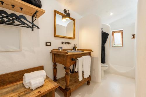 a bathroom with a wooden sink and a toilet at NEST Baja in San José del Cabo