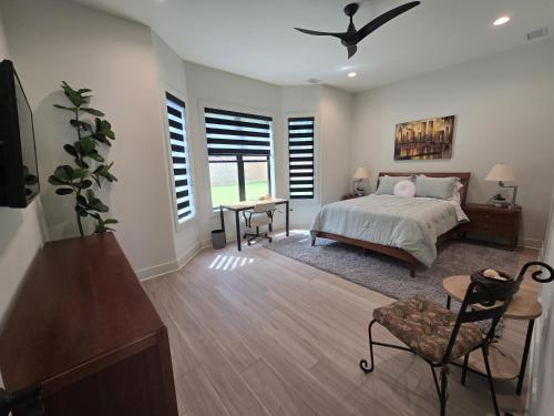 a bedroom with a bed and a desk and window at Modern ranch retreat near Trilith and US Soccer Training Facilities in Fayetteville