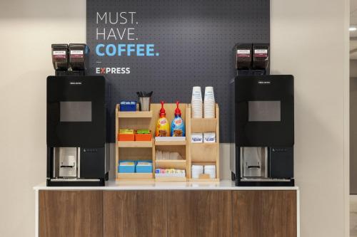 a coffee shop with two espresso machines on a counter at Holiday Inn Express Fayetteville Fort Bragg by IHG in Fayetteville