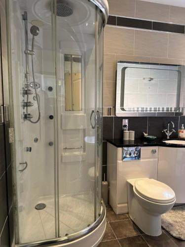 a bathroom with a shower and a toilet at Comfy Stay Near City & Station in Preston