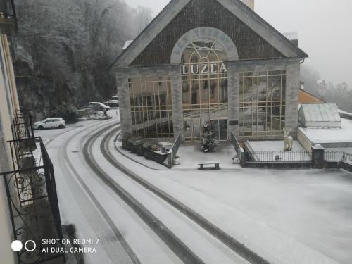 a building in the snow with train tracks in front at Appartement T3 2 chambres - 6 personnes in Luz-Saint-Sauveur