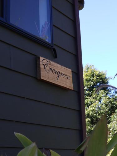 a sign on the side of a house at Hideaway Falls - Evergreen Cottage in Mapleton