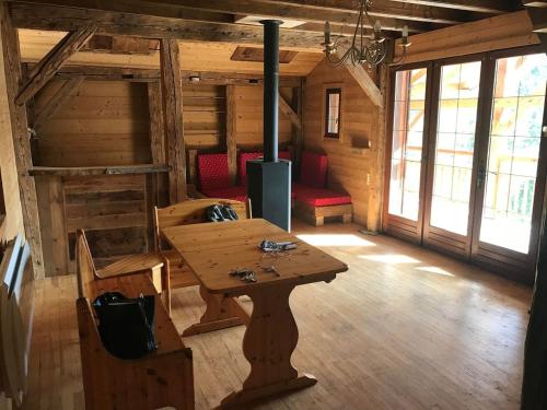 a room with a wooden table and chairs in a cabin at Chalet Chamois & Spa in Lullin
