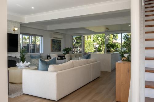 a living room with a couch and a table at Solar Pool & Luxury Beach Villa in Bokarina
