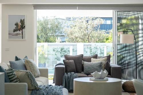 a living room with a couch and a table at Solar Pool & Luxury Beach Villa in Bokarina
